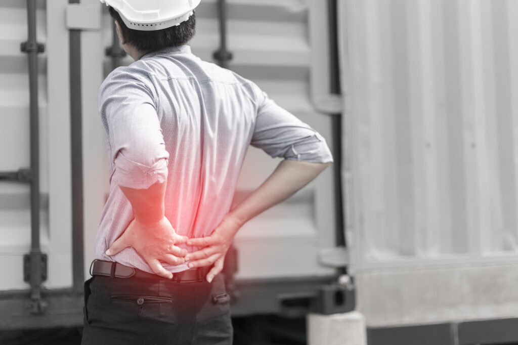 An injured engineer with back pain radiating in red